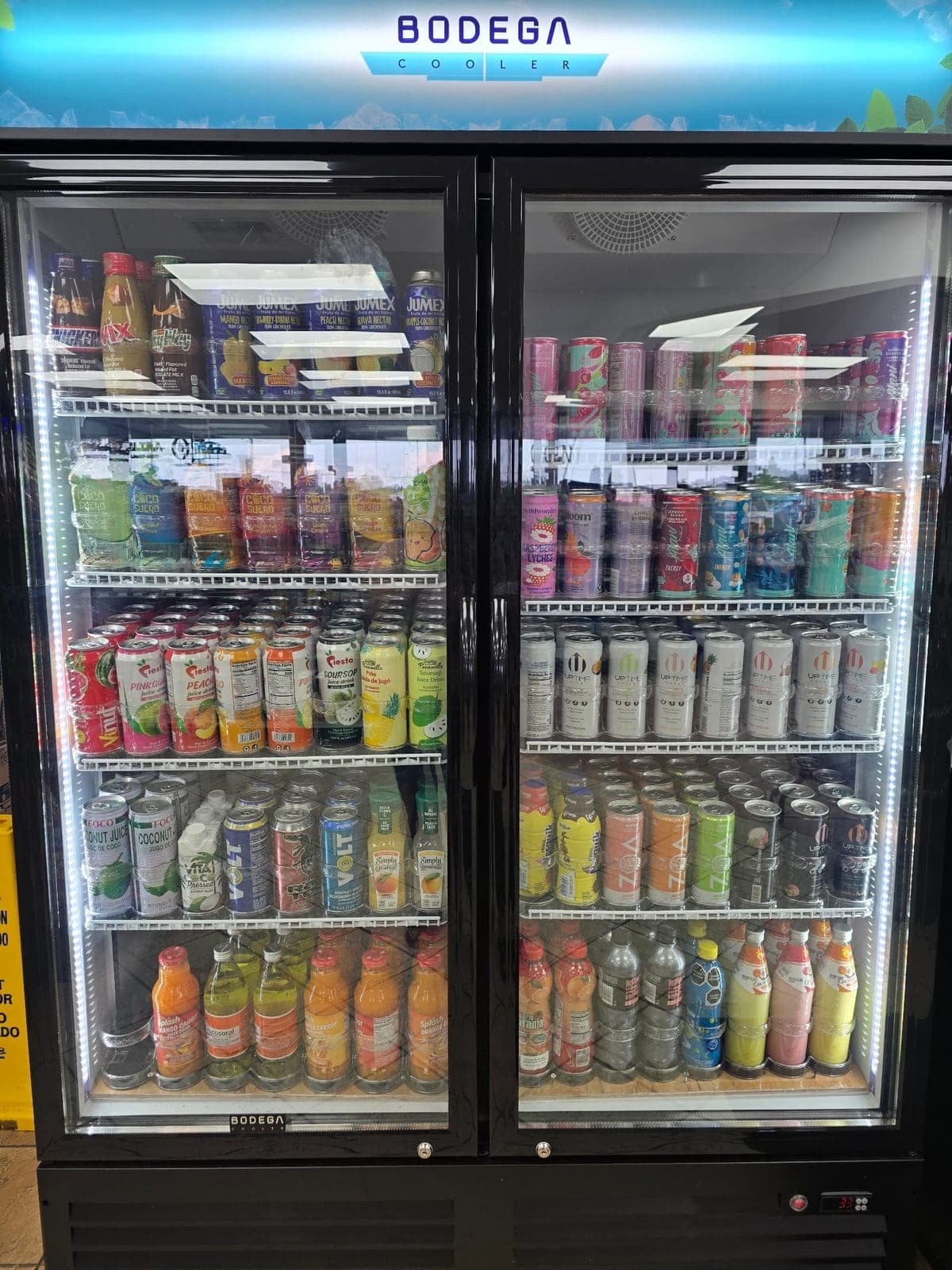 Cooler at Bent Creek Grocery stocked with juices, coconut water and energy drinks
